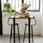 Genuine Nicolle metal chair measuring 30-inch in height, paired with a Tiptoe table. Perfect combination of style and durability from Chaises Nicolle.