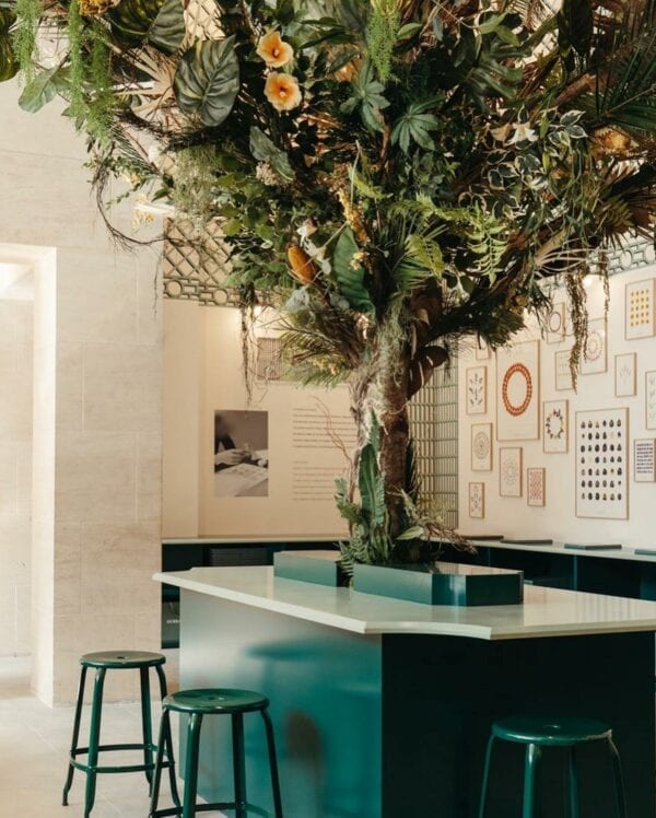 Green metal stool with a height of 65cm at Herbarium