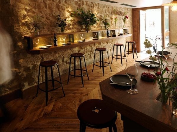 Nicolle metal bar stool H30-inch. Metal stool with patinated steel finish and leather cushion at Freddy's Restaurant in Paris.