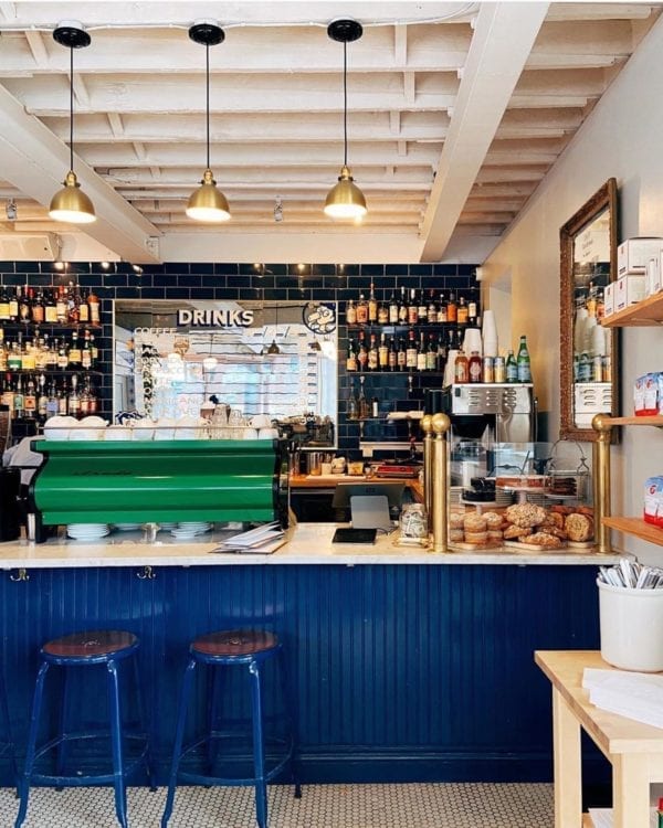 Chaises Nicolle 60-cm metal stool. Nicolle blue stools at the counter of a shop in the USA.