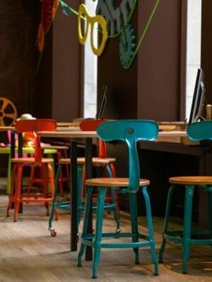 A wooden and metal chair with a height of 18-inch at Kid Optic. Perfect for modern interiors. Manufactured by Chaises Nicolle.