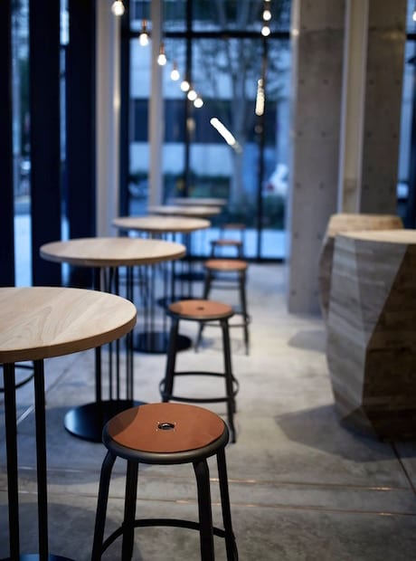 Chaises Nicolle metal and leather swivel stool at a Tokyo restaurant bar, with leather cushions.