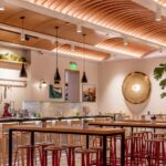 Nicolle high stool with wood and metal at The Hall Global Eatery, Amar Santana, Costa Mesa, USA.