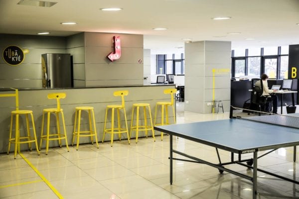Yellow Chaises Nicolle chairs and stools in a coworking space in Lyon