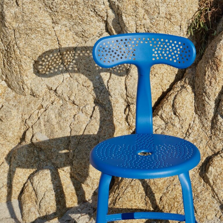 Outdoor metal chair by Chaises Nicolle with a whale tail backrest, 45-cm seat height.