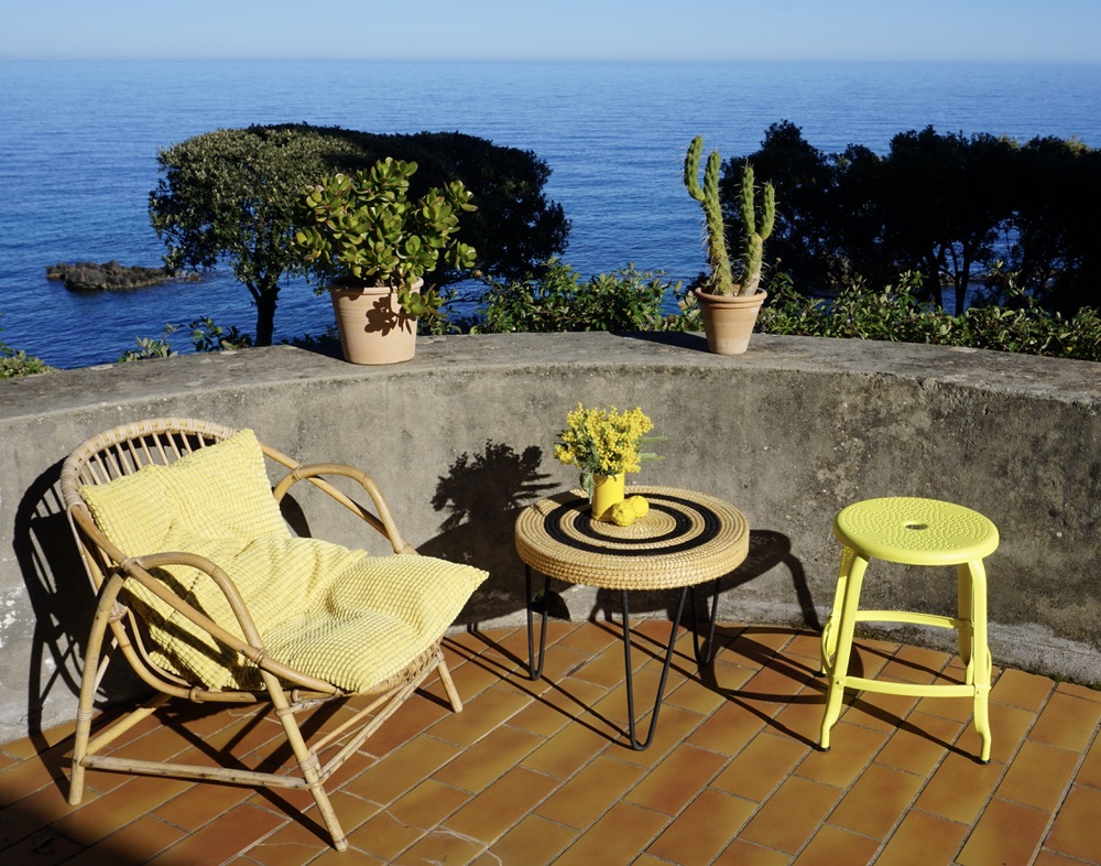Perforated metal stool on a seaside terrace