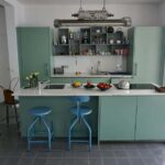 Adjustable Nicolle chair and stool in a kitchen