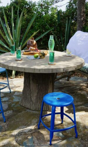 Outdoor metal chair Nicolle, 45-cm in height, next to an outdoor concrete table and another metal chair.