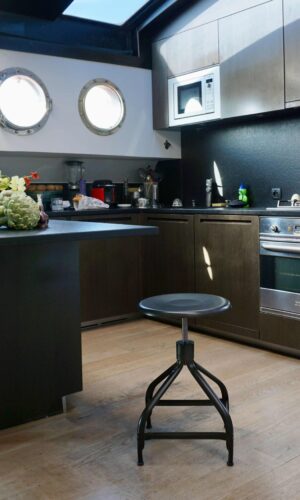 Adjustable metal stools in a kitchen by Chaises Nicolle