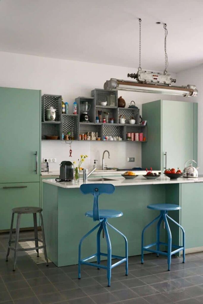 Adjustable metal chair and bar stool in a modern kitchen from Chaises Nicolle.